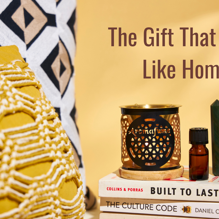 The gift that feels like home – a cozy setup with an essential oil burner, pillows, and books for a warm, inviting space.