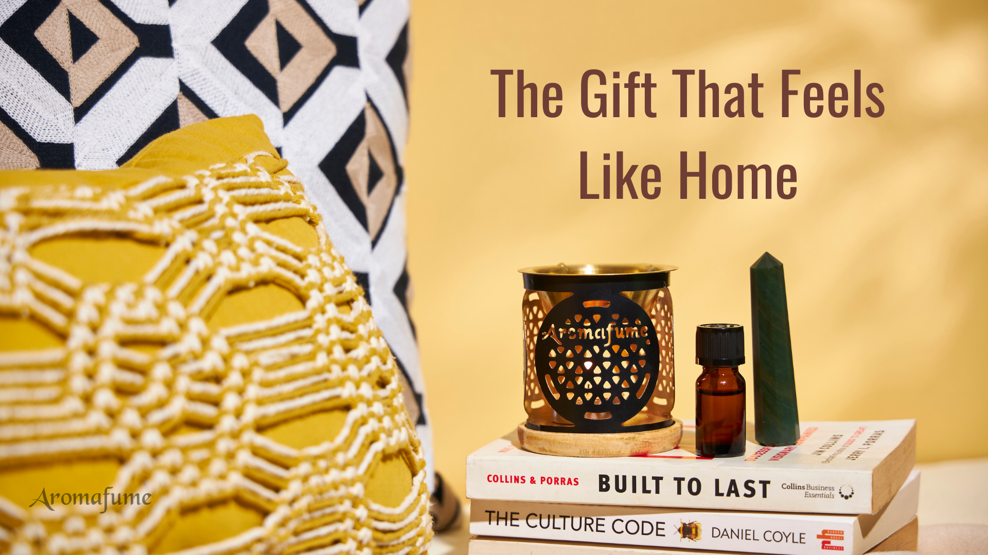 The gift that feels like home – a cozy setup with an essential oil burner, pillows, and books for a warm, inviting space.